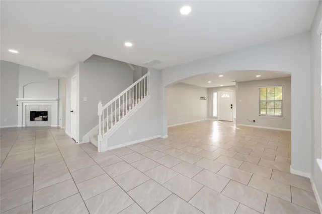 a view of a livingroom with a fireplace and window