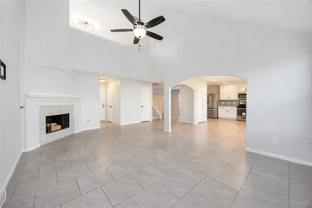 a large kitchen with white cabinets and stainless steel appliances