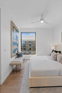 a bedroom with a large bed and a large window