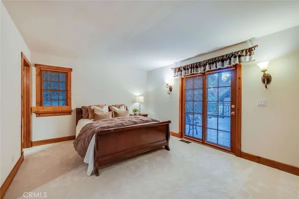 a bedroom with a bed and a lamp