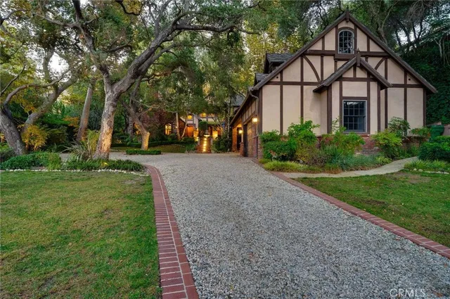 a front view of a house with a garden