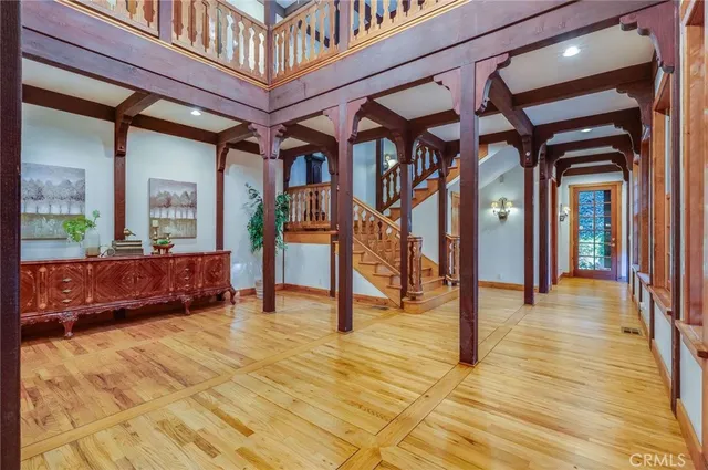 a dining room with furniture a chandelier and wooden floor