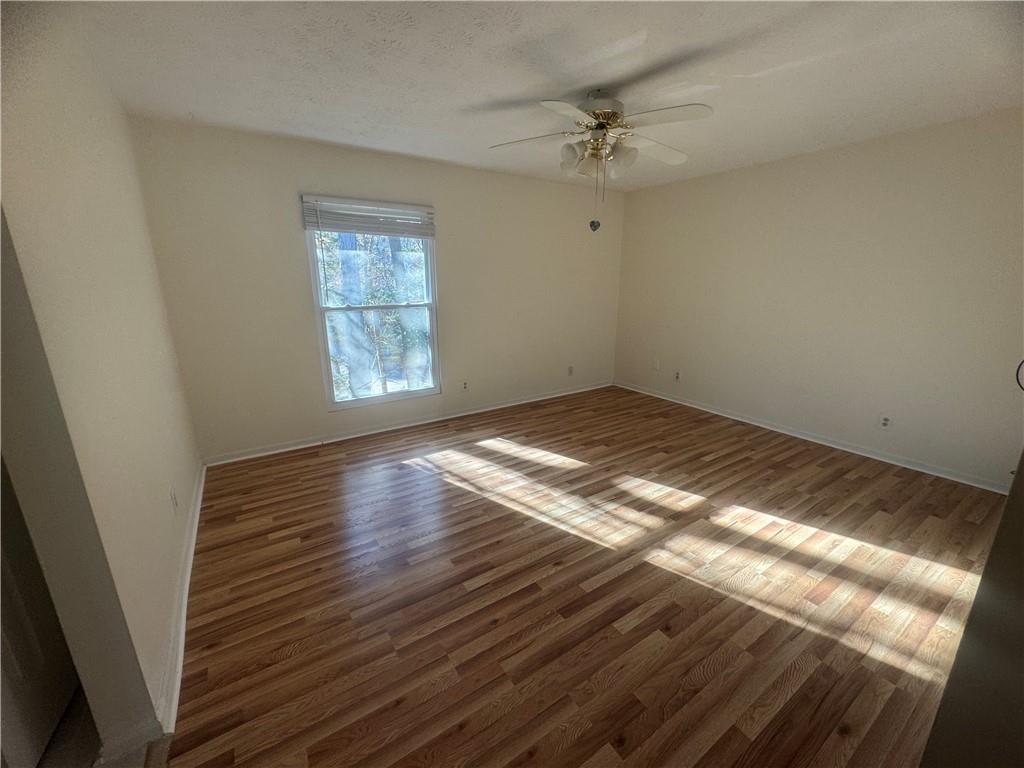 3563 Splinterwood Road Peachtree Corners, GA 30092 - Photo 11 of 13 a view of empty room with wooden floor and fan