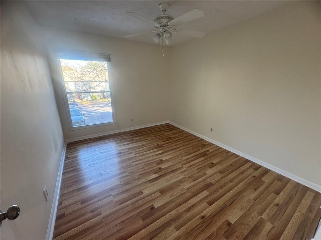 3563 Splinterwood Road Peachtree Corners, GA 30092 - Photo 5 of 13 wooden floor in an empty room with a window