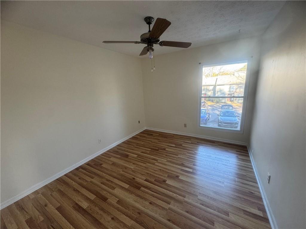 3563 Splinterwood Road Peachtree Corners, GA 30092 - Photo 7 of 13 wooden floor in an empty room and a window