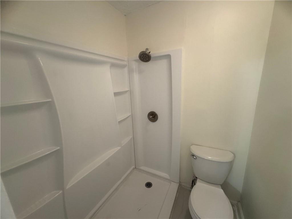 3563 Splinterwood Road Peachtree Corners, GA 30092 - Photo 9 of 13 a bathroom with a toilet and shower