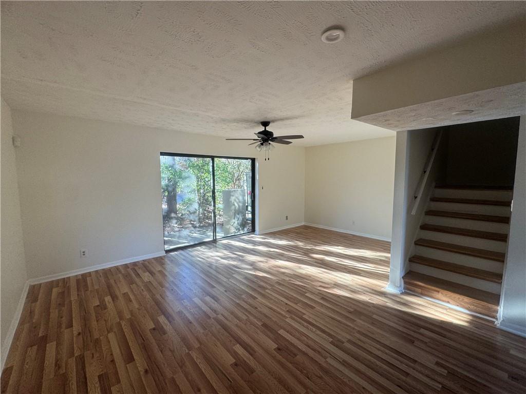 3563 Splinterwood Road Peachtree Corners, GA 30092 - Photo 10 of 13 wooden floor in an empty room with a window