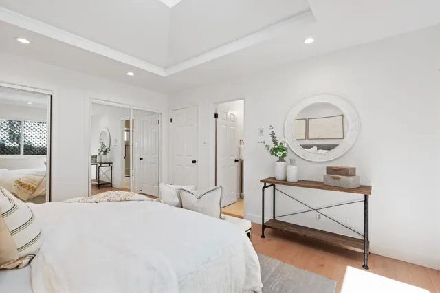 a bathroom with a granite countertop sink a mirror a toilet and shower