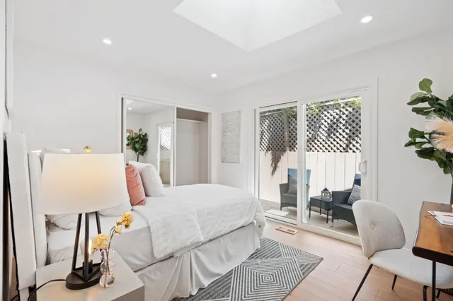 a bedroom with a bed and a potted plant