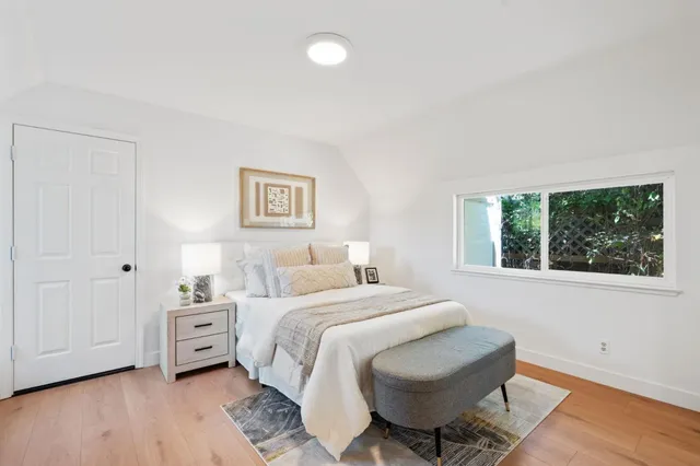 a bedroom with a bed and a window