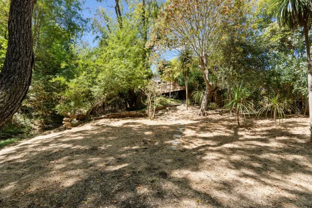 a view of a house with swimming pool and sitting area