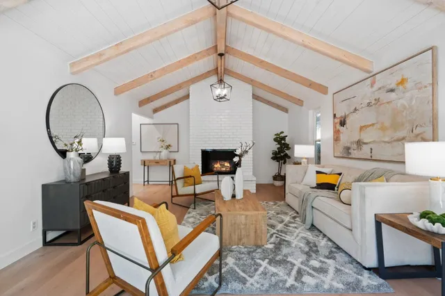 a living room with fireplace furniture and a chandelier