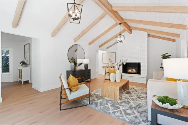 a living room with furniture a rug and a chandelier