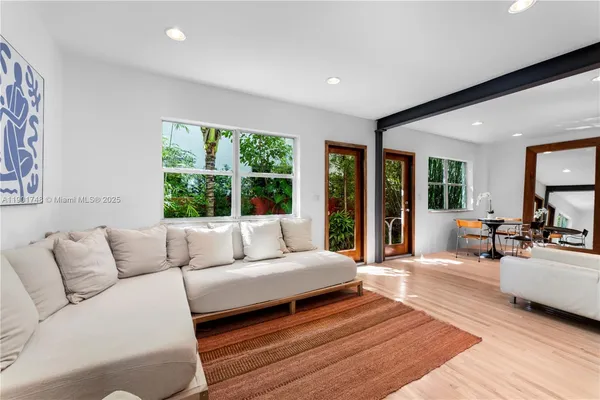 a living room with furniture and a large window
