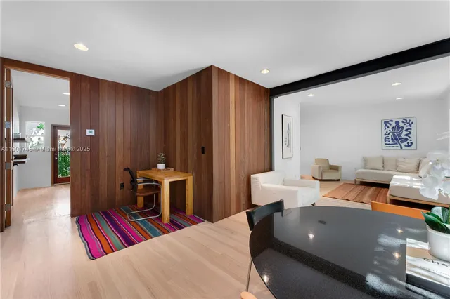 a living room with furniture and a pool table