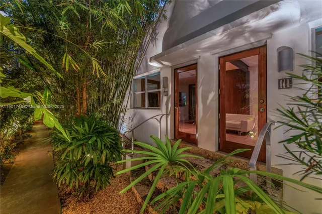 a couple of potted plants in front of building