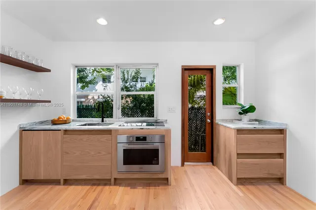 a view of kitchen with wooden floor and electronic appliances