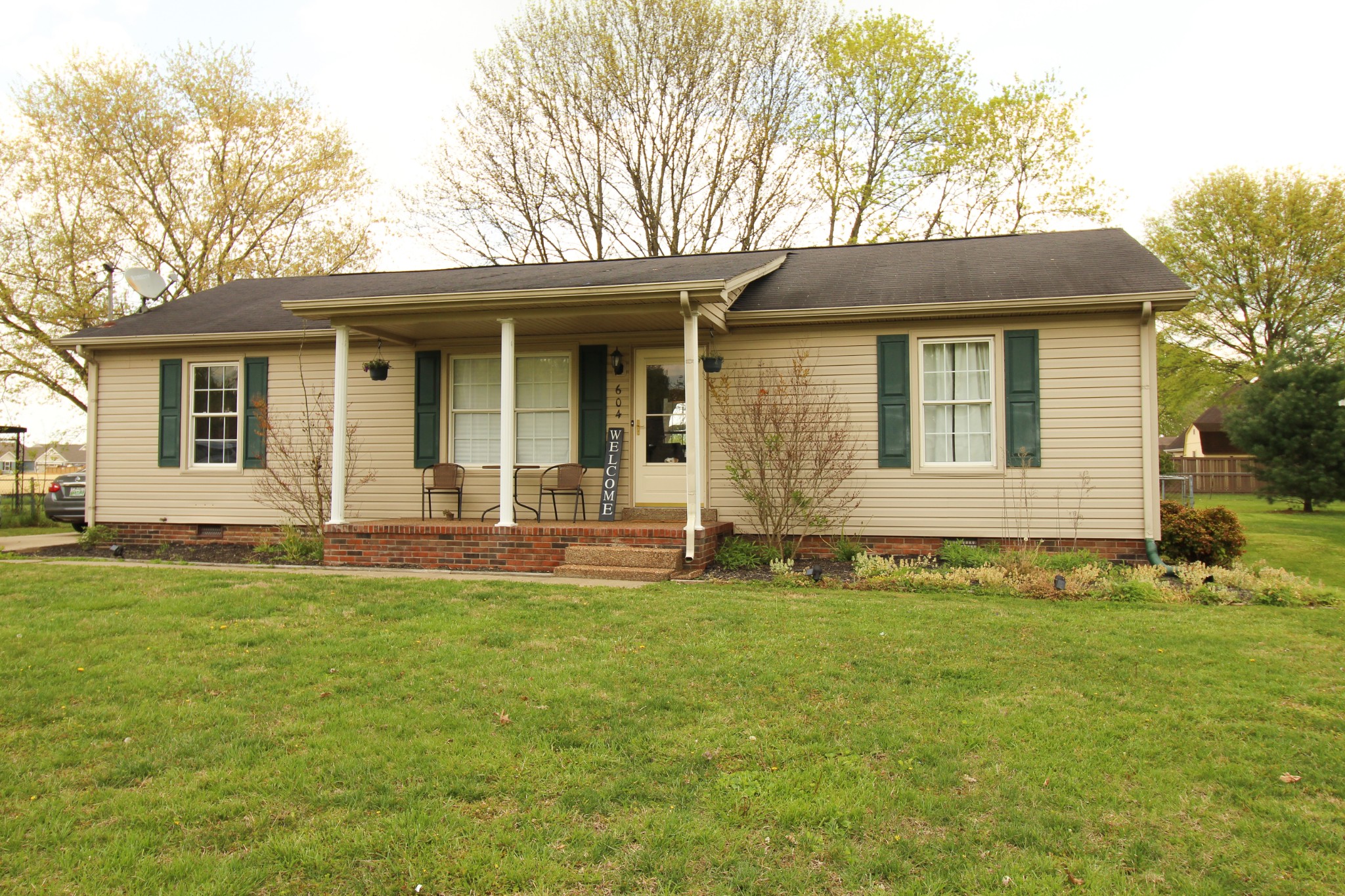 604 Calista Road White House, TN 37188 - Photo 1 of 7 a front view of a house with a garden and yard