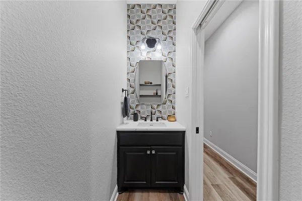 a bathroom with a sink and a mirror