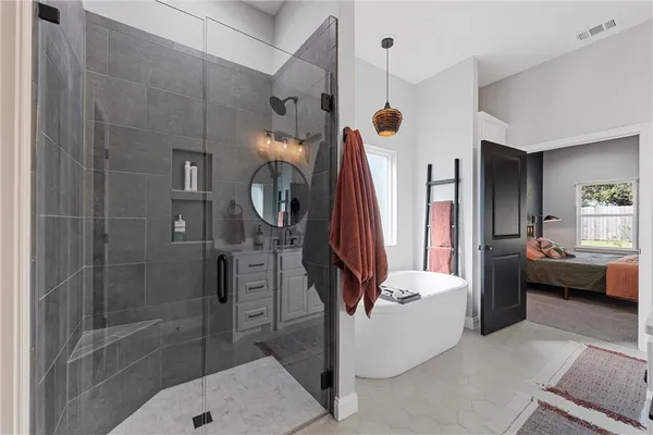 a bathroom with a tub shower and bathroom
