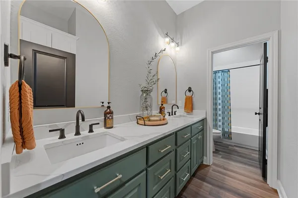 a bathroom with a double vanity sink and a mirror