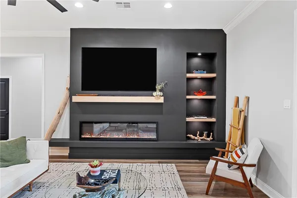 a living room with a fireplace and a flat screen tv