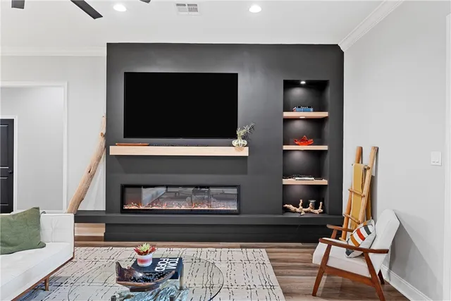 a living room with a fireplace and a flat screen tv