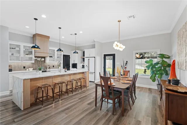 a large kitchen with a table and chairs