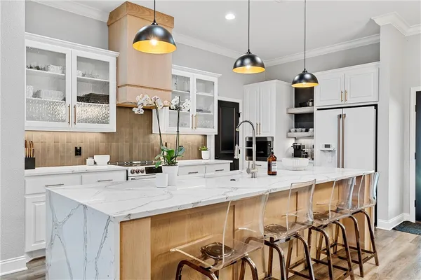 a kitchen with stainless steel appliances granite countertop a sink and a refrigerator