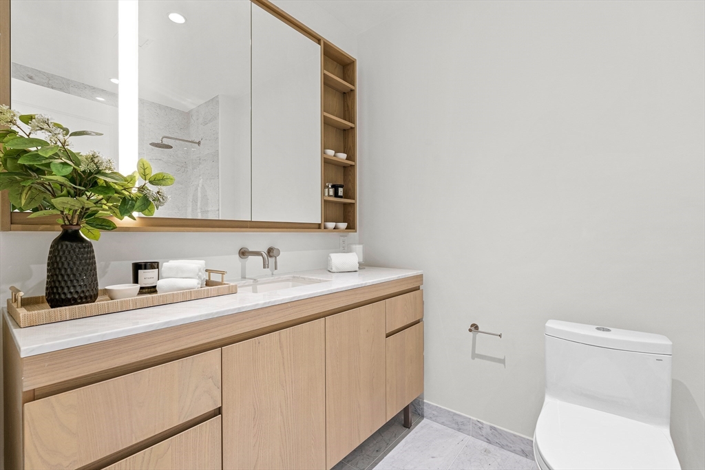 40 Trinity Place, Unit 31D Boston, MA 02116 - Photo 12 of 38 a bathroom with a toilet sink and mirror