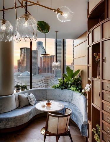 a living room with furniture chandelier and a large window