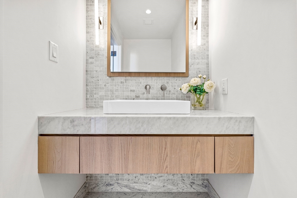 40 Trinity Place, Unit 31D Boston, MA 02116 - Photo 7 of 38 a bathroom with a sink and a mirror