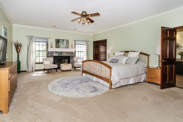 5N884 Dunham Trails Road Wayne, IL 60184 - Photo 11 of 26 a spacious bedroom with a bed a couch and a chandelier