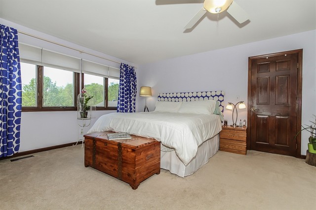 5N884 Dunham Trails Road Wayne, IL 60184 - Photo 14 of 26 a spacious bedroom with a bed and a chandelier