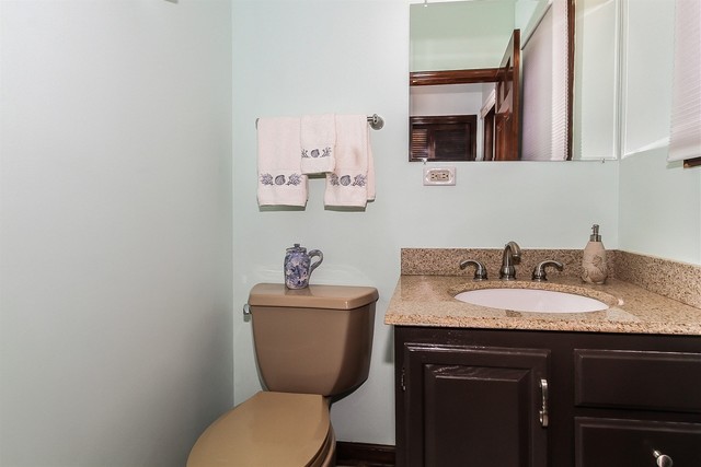 5N884 Dunham Trails Road Wayne, IL 60184 - Photo 15 of 26 a bathroom with a granite countertop toilet sink and mirror