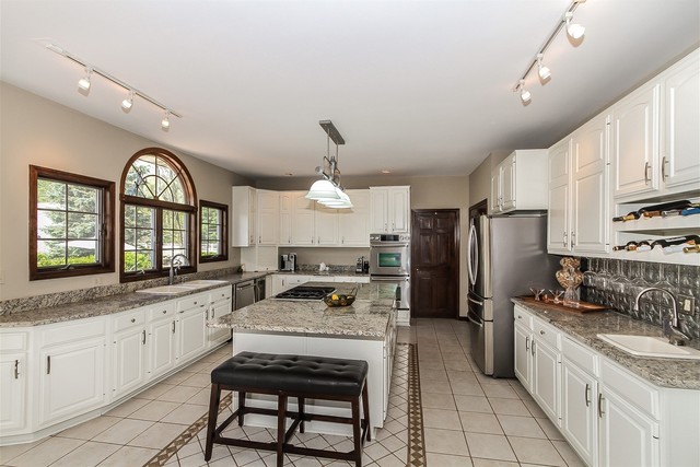 5N884 Dunham Trails Road Wayne, IL 60184 - Photo 6 of 26 a large kitchen with granite countertop a stove a sink dishwasher a refrigerator and cabinets with wooden floor