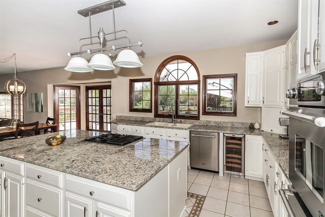 5N884 Dunham Trails Road Wayne, IL 60184 - Photo 7 of 26 a kitchen with stainless steel appliances granite countertop a stove and a sink