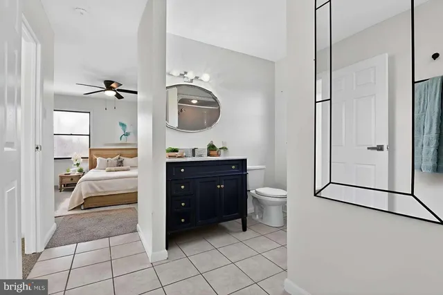 a kitchen with a refrigerator a stove top oven a counter space and wooden floor