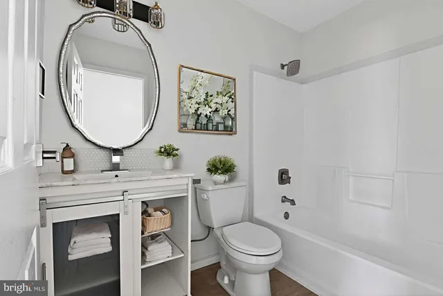 a kitchen with stainless steel appliances granite countertop a sink cabinets and wooden floor