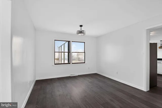 a kitchen with white cabinets and appliances