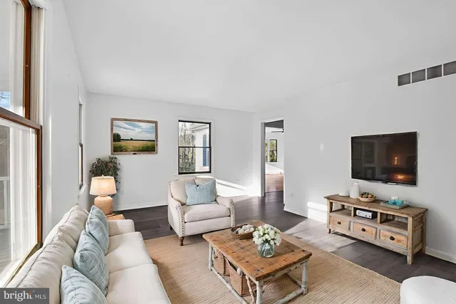 a spacious bathroom with a granite countertop sink a toilet and a mirror