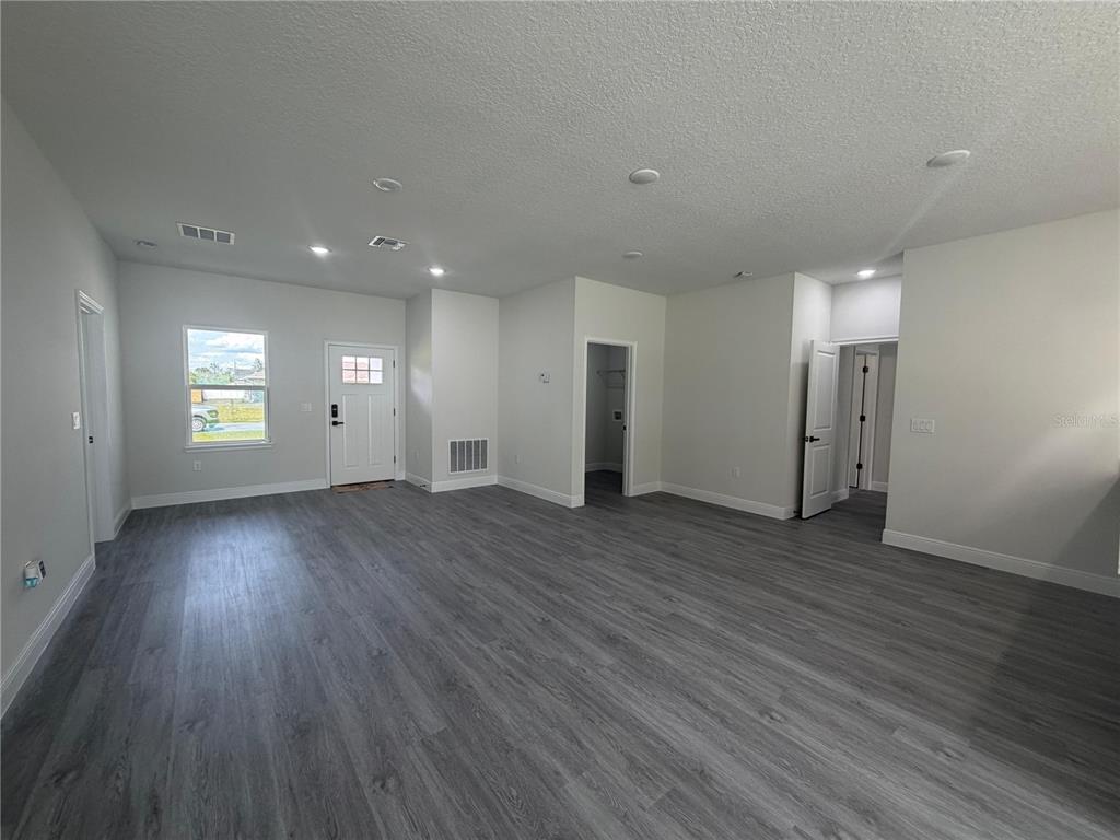 16252 Southwest 27th Terrace Road Ocala, FL 34473 - Photo 12 of 15 an empty room with wooden floor and windows