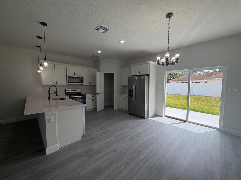16252 Southwest 27th Terrace Road Ocala, FL 34473 - Photo 13 of 15 a open kitchen with refrigerator and microwave