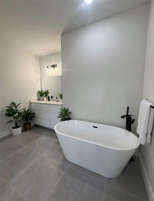 16252 Southwest 27th Terrace Road Ocala, FL 34473 - Photo 5 of 15 a white bath tub sitting in a bathroom