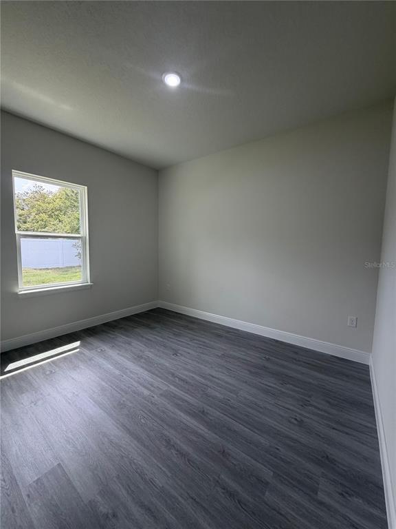 16252 Southwest 27th Terrace Road Ocala, FL 34473 - Photo 8 of 15 an empty room with wooden floor and windows