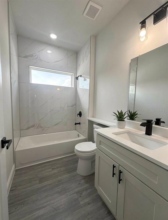 16252 Southwest 27th Terrace Road Ocala, FL 34473 - Photo 9 of 15 a bathroom with a double vanity sink toilet and shower