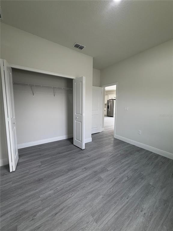16252 Southwest 27th Terrace Road Ocala, FL 34473 - Photo 10 of 15 a view of an empty room with wooden floor and a window