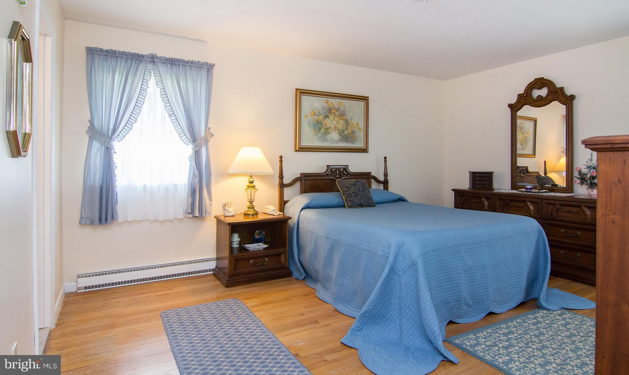 1104 Sturbridge Road Fallston, MD 21047 - Photo 13 of 28 a bedroom with a bed and wooden floor