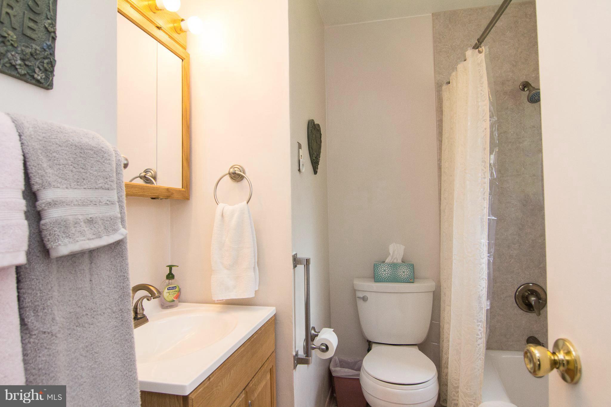 1104 Sturbridge Road Fallston, MD 21047 - Photo 14 of 28 a bathroom with a granite countertop sink a toilet and shower