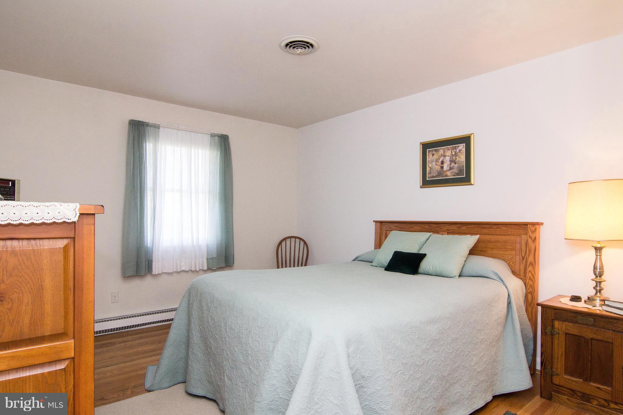 1104 Sturbridge Road Fallston, MD 21047 - Photo 15 of 28 a bedroom with a bed and a lamp